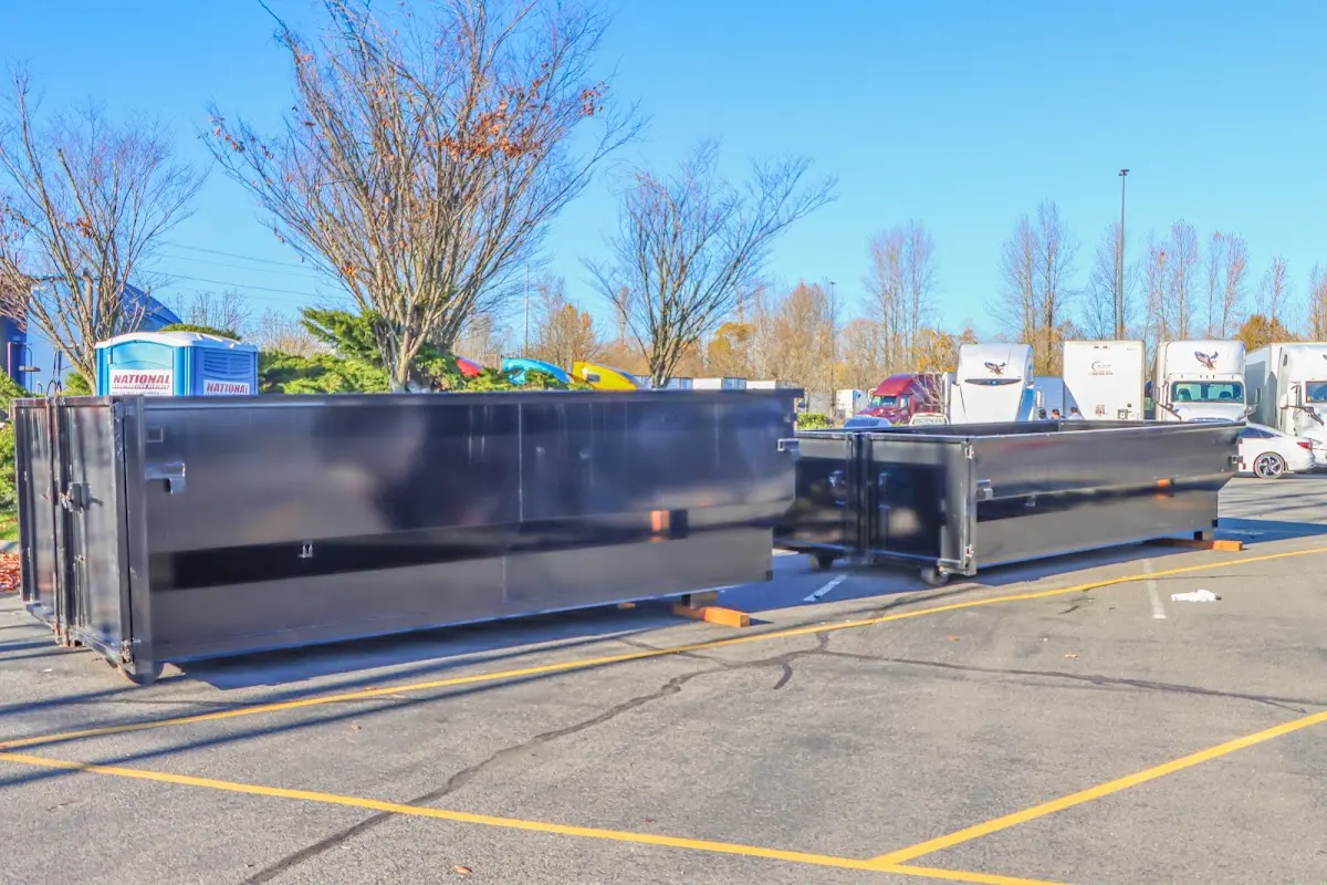 Professional dumpster rental service with roll-off container on residential driveway in Halifax